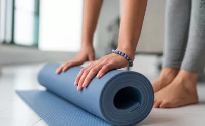 Yoga zu Hause eine Frau rollt Übungsmatte im Wohnzimmer des Hauses auf